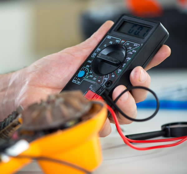 electrician checking voltage on meter